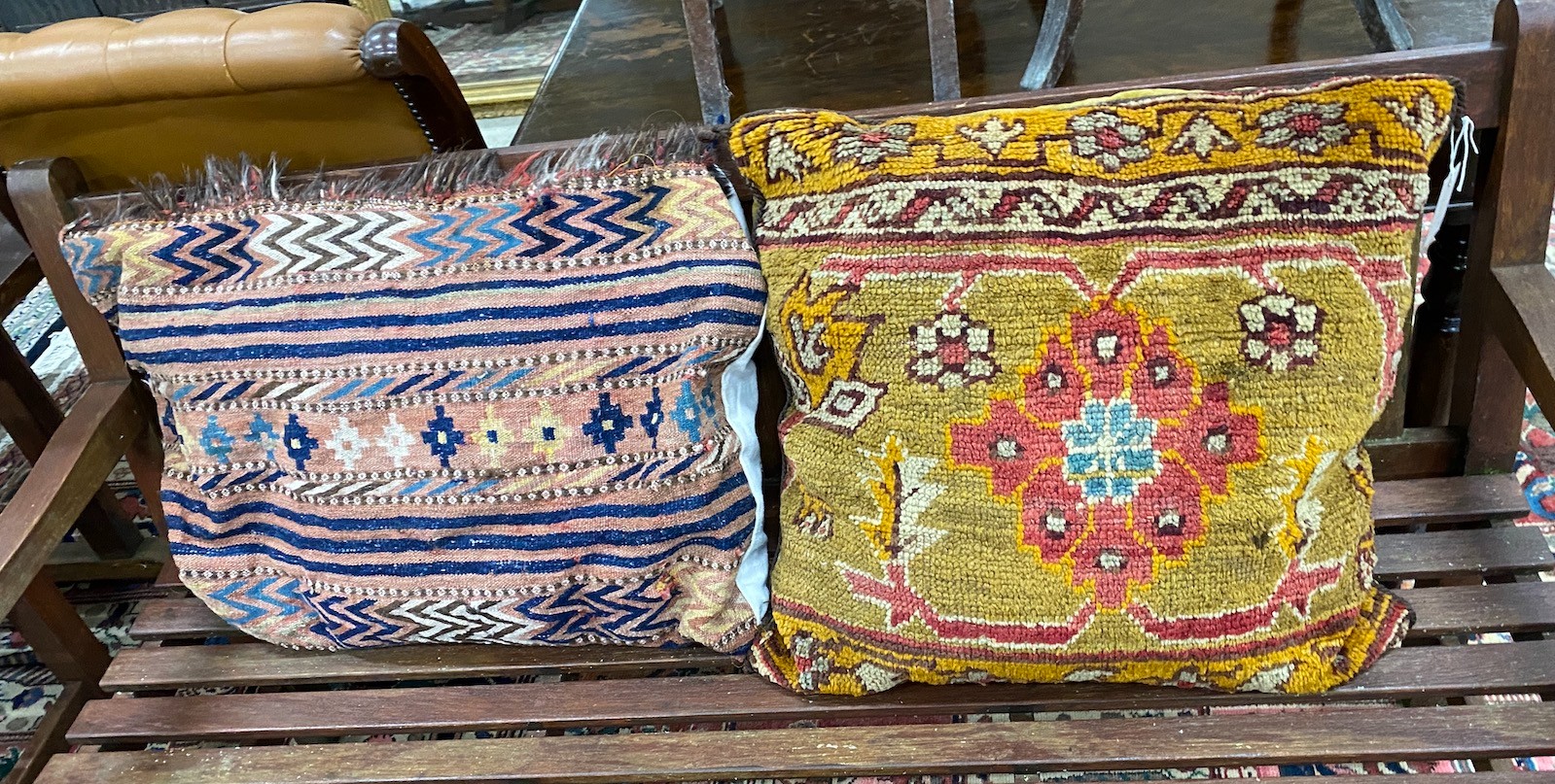 Two Turkish carpet fragment cushions, larger 72 x 50cm